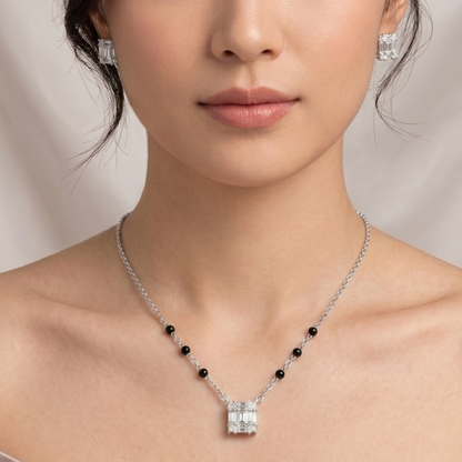 Shop 925 sterling silver mangalsutra sets at Kimaaya. Discover the Aurelia set with black beads, a geometric stone-studded pendant and matching earrings.