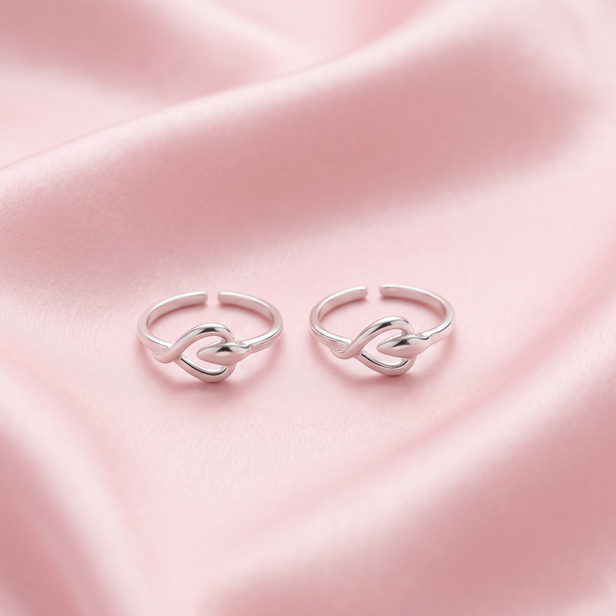 Two 925 silver adjustable toe rings with a heart-shaped knot design