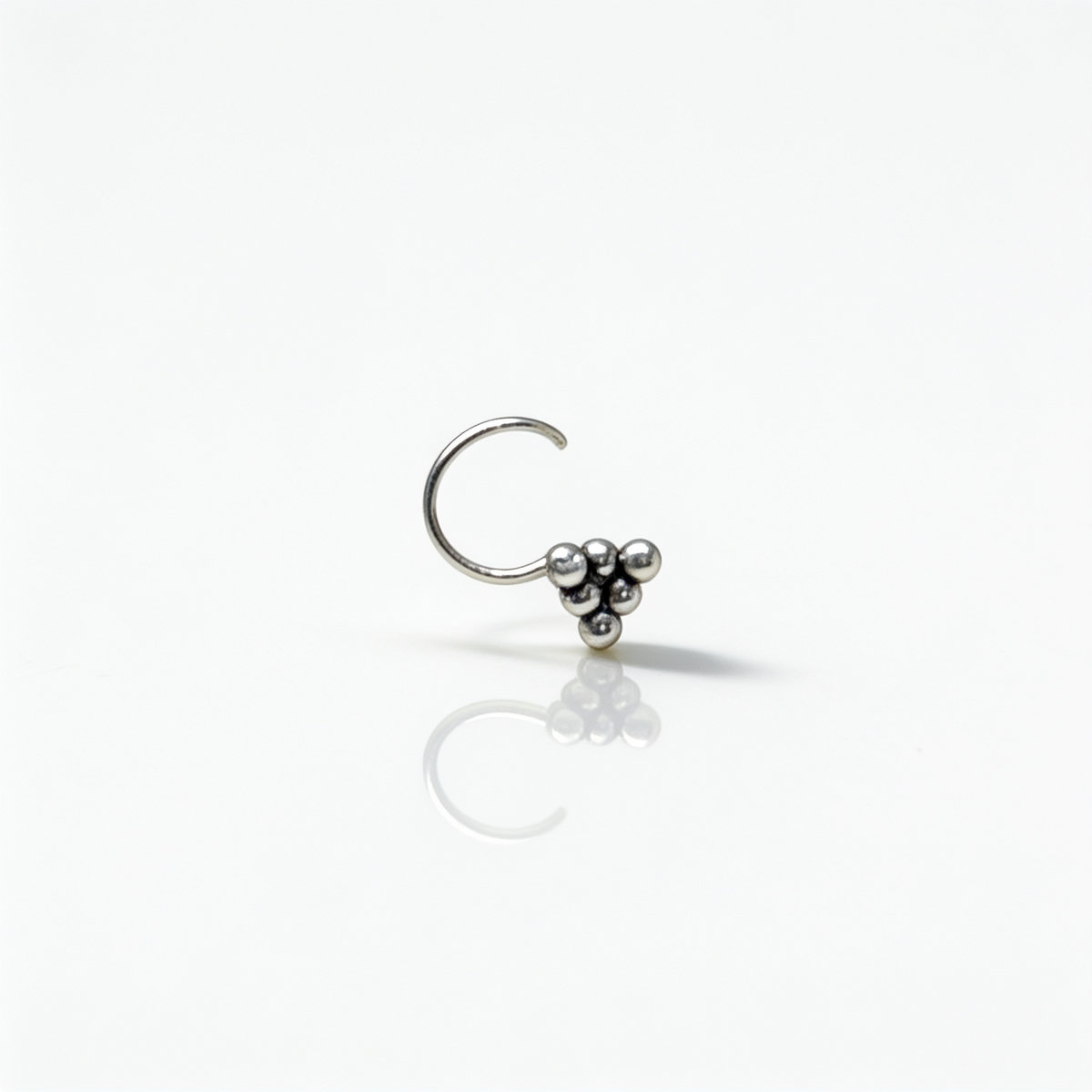 Minimalist 925 sterling silver nose pin featuring three tiny silver beads arranged in a triangular pattern.