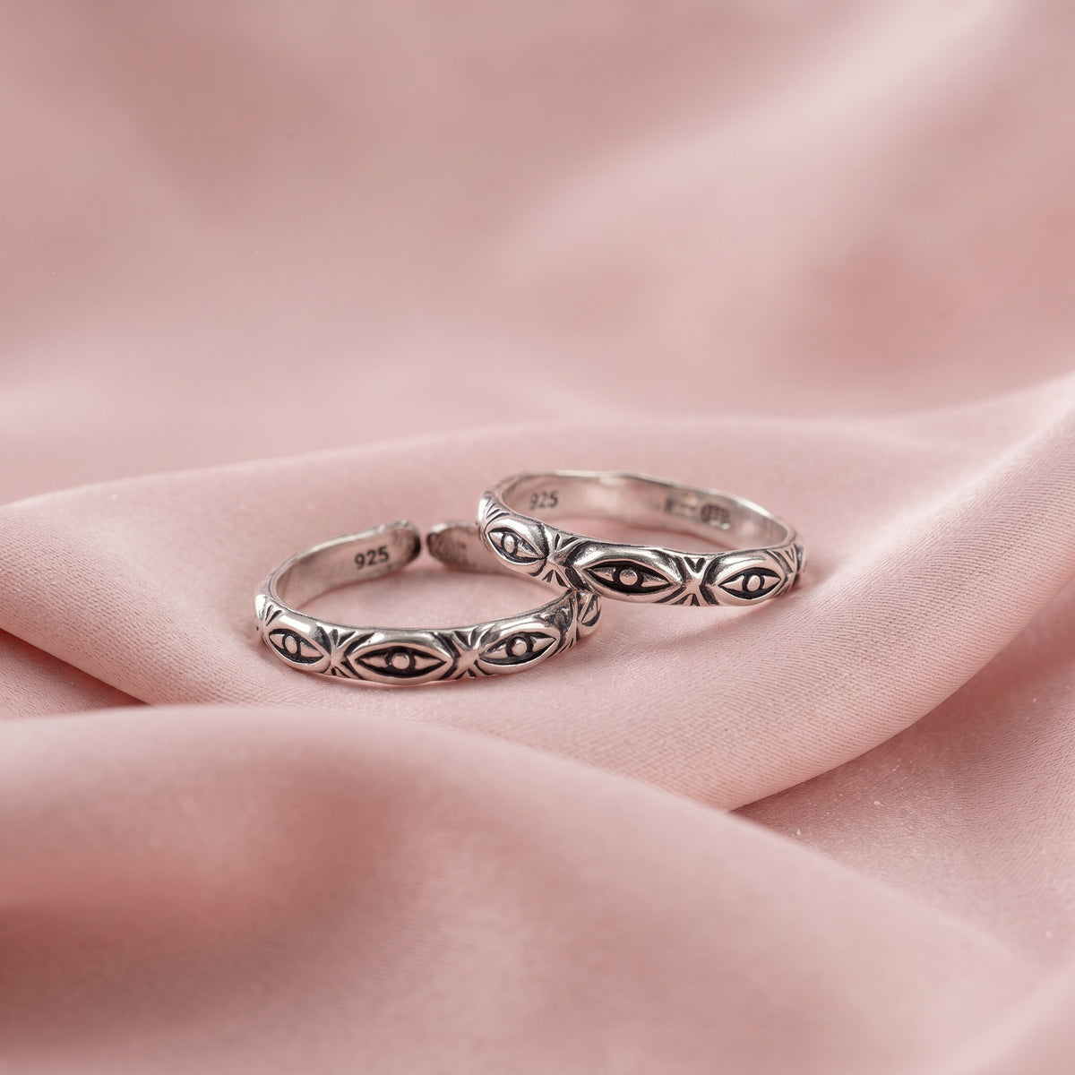 Two silver rings with engraved eye motifs