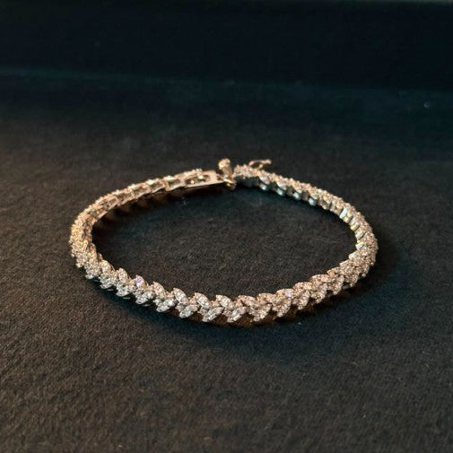 A diamond tennis bracelet with a silver -toned setting