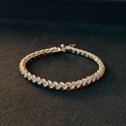 A diamond tennis bracelet with a silver -toned setting